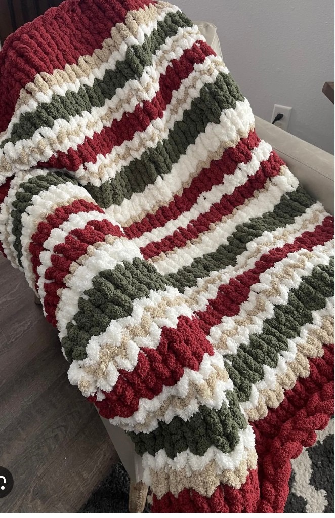 Burgundy, green, white, and beige striped chunky knit blanket