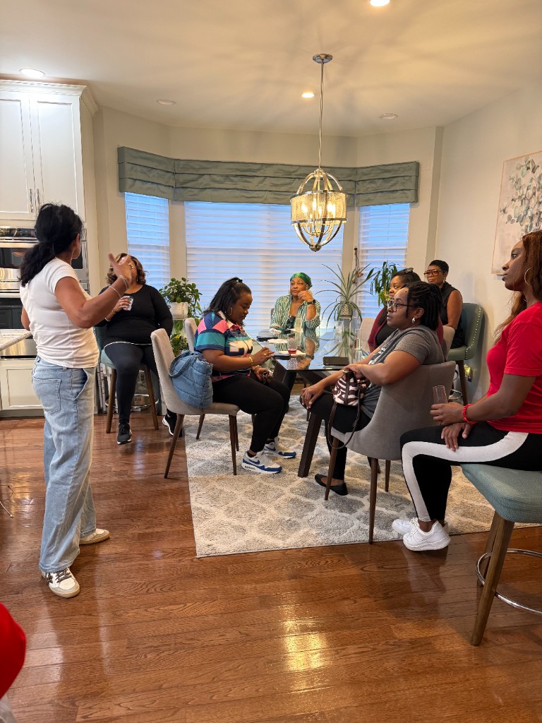 Guests gathered around a dining table during the Patch Your Pride event