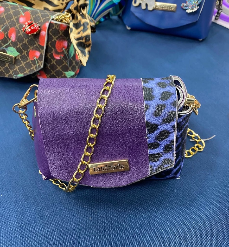 A purple and blue leopard handmade purse with a gold chain