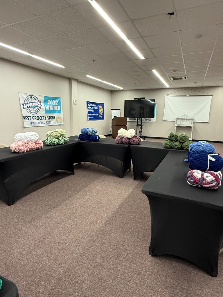 Yarn colors laid out on tables before the Wrapped in Strength workshop